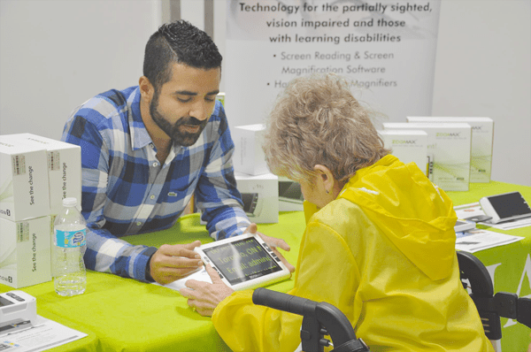 Jad Nohra managing director introducing Zoomax Snow 7 HD Plus to a visitor in the CNIB Simcoe Muskoka 2017