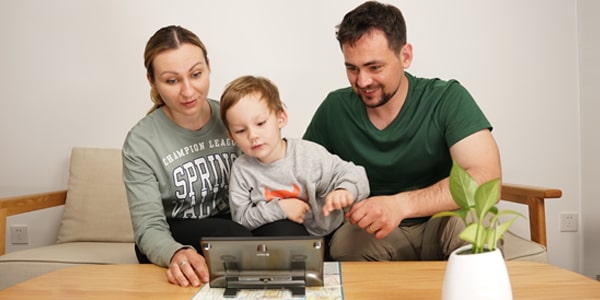 A family trying Luna 8 video magnifier for low vision