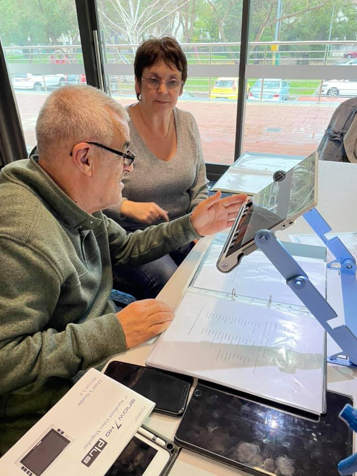 People using Zoomax Snow 12 to read text at Deafblind West Australians