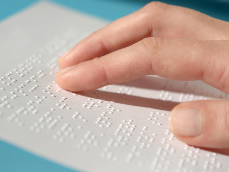 blind woman reading text in braille